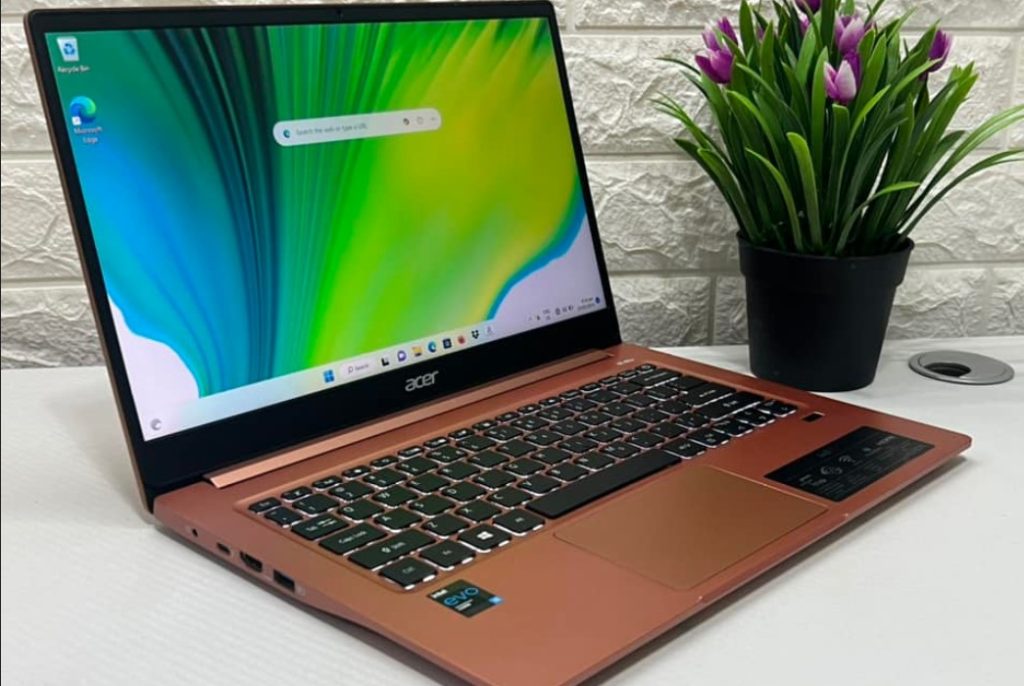 Close-up image of Acer Swift 3 on the table, beside a flower pot. The laptop is owned by one of our team member.